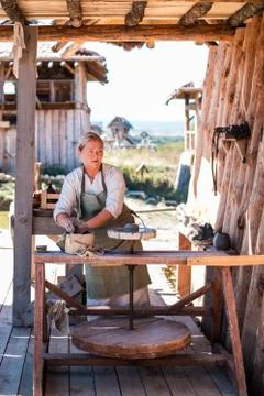 Potter is creating earthenware on potter's wheel. Stock Photos