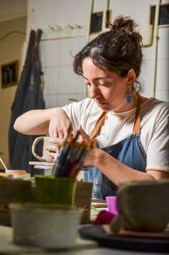 Potter creating handmade ceramic mug in workshop Stock Photos
