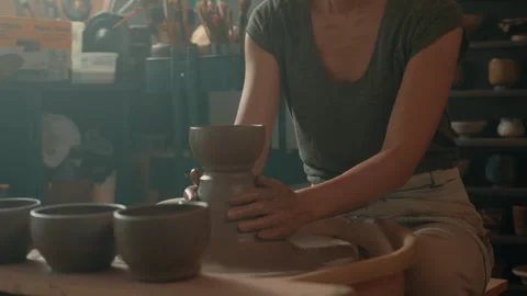Potter creating set of bowls on pottery wheel in studio Stock Footage 275086679