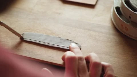 The potter cuts the clay into the desired shape with a knife. handwork. craft Stock Footage 145534518