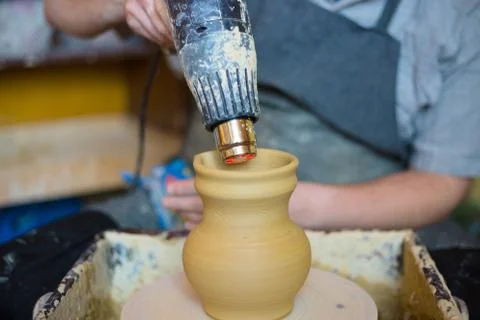 Potter drying ceramic pot with special dryer Stock Photos
