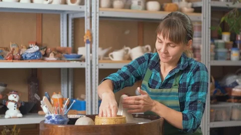 Potter girl in the workshop. The process of creating ceramics on a circle Stock Footage 128627840