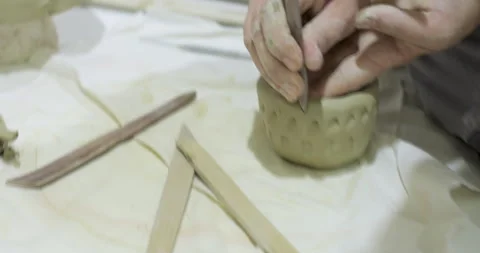 Potter Hand Carving Decorative Pattern onto Clay Bowl with Precision Tool Stock Footage 304414641
