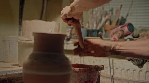 Potter hands attached handle of clay jug. Craftsman artist forming unfinished Stock Footage 258256159