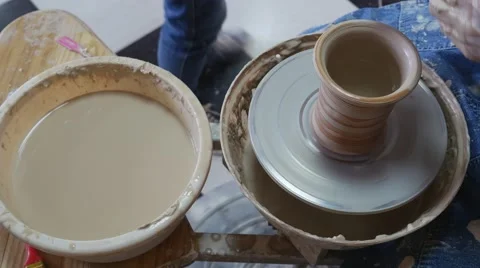 Potter Hands Close up is Glazing a Pot by Brush Working on a Potter's Wheel in 動画素材 57997007