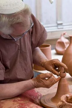 Potter in his workshop. Stock Photos