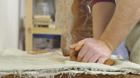 Potter kneads the clay Stock Footage 101320553