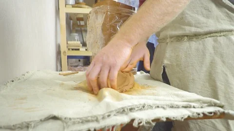 Potter kneads the clay Stock Footage 101570264