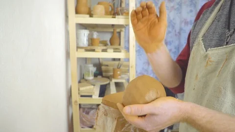 The Potter kneads the clay in the Studio Stock Footage 108208501
