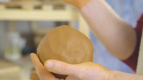 The Potter kneads the clay in the Studio Stock Footage 108210342