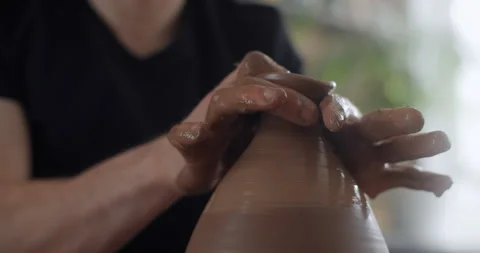 Potter makes a jug in slow motion on a potter's wheel, video from pottery Stock Footage 150818893
