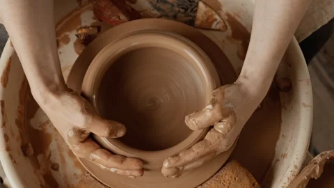 Potter making ceramic plate on pottery wheel. Top view. Clay product Stock Footage 245695912