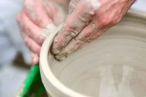 Potter making ceramic pot on the pottery wheel Stock Photos