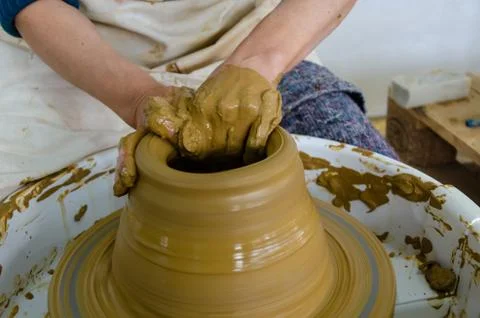 Potter making ceramic pot on the pottery clay Stock Photos