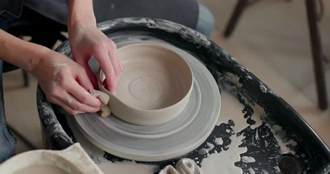 Potter making ceramic pot on the rotated pottery wheel. Female potter at work Stock Footage 155925230
