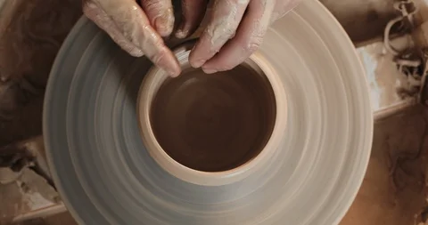 Potter making ceramic pot on the twisted pottery wheel. Top view. Potter at work Video stock 105996326