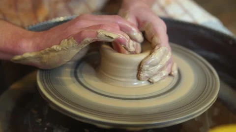 Potter making ceramic pot on the twisted pottery wheel.Potter at work, close up. Stock Footage 162811160