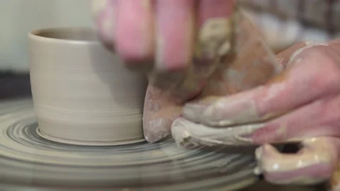 Potter making ceramic pot on the twisted pottery wheel.Potter at work, close up. Stock Footage 162811254