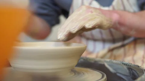 Potter making ceramic pot on the twisted pottery wheel.Potter at work, close up. Stock-Footage 162811372