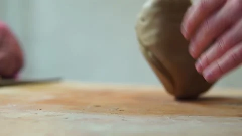 Potter making ceramic pot on the twisted pottery wheel.Mixing Potter Stock-Footage 162811943