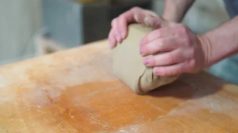 Potter making ceramic pot on the twisted pottery wheel.Mixing Potter Stock-Footage 162811988