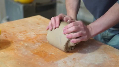 Potter making ceramic pot on the twisted pottery wheel.Mixing Potter Stock-Footage 162812040