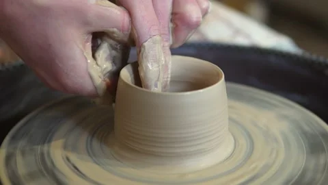 Potter making ceramic pot on the twisted pottery wheel.Potter at work, close up. Stock-Footage 162812339