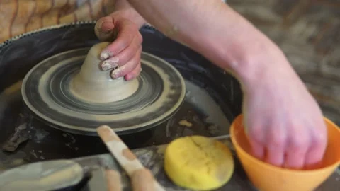 Potter making ceramic pot on the twisted pottery wheel.Potter at work, close up. Stock-Footage 162812386
