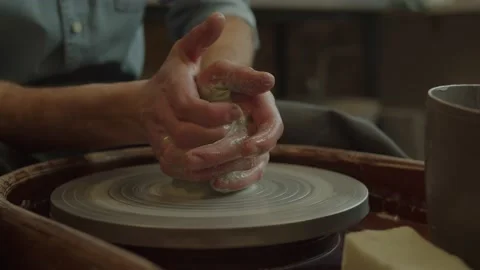 Potter making ceramic pot on the twisted pottery wheel. Top view. Potter at work Video stock 236202335