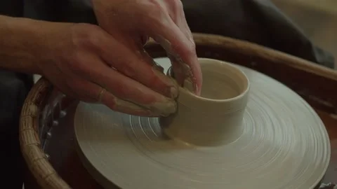 Potter making ceramic pot on the twisted pottery wheel. Top view. Potter at work Video stock 236202354