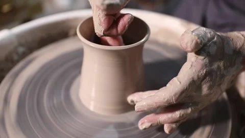 A potter making a mug on a potters wheel Stock Footage 228257569