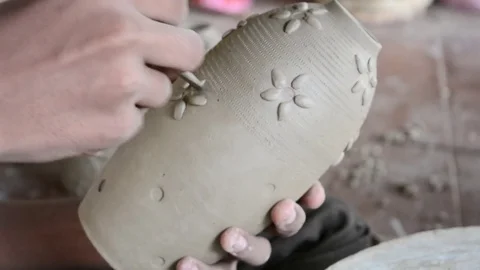 Potter making pot and brushing Stock Footage 70347881