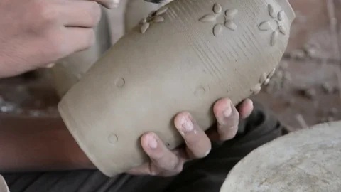 Potter making pot and brushing Stock Footage 70348847