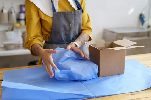 Potter master prepare parcel with handmade ceramics to deliver. Female studio Stock Photos