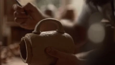 Potter mounts a handle to a jug Stock Footage 233725271