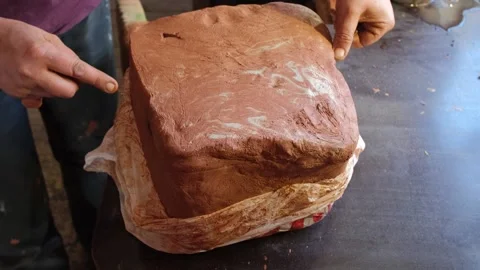The potter prepares the material for work. A piece of clay is cut with a thread  Stock Footage 219566471