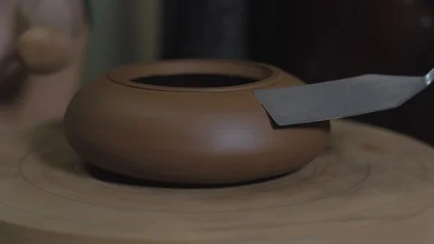 Potter processes the teapot from Yixing clay with a metal spatula Stock Footage 119000272