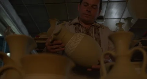 Potter puts a clay jug on a pushcart. Stock Footage 101288155