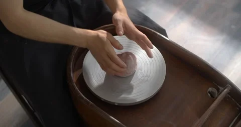 Potter puts colored clay to the potter's wheel for sculpting ceramics in Stock Footage 150932260