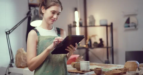 Potter Reviewing Ceramic Designs on Tablet in Studio Stock Footage 274422290