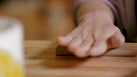 The potter rolls a piece of clay on the table. Studio. Craft.  Close-up. Stock Footage 169710970
