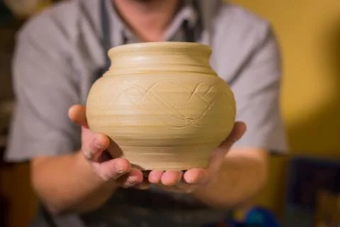 Potter showing earthenware pot Stock Photos
