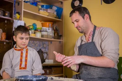Potter showing how to work with ceramic in pottery studio Stock Photos