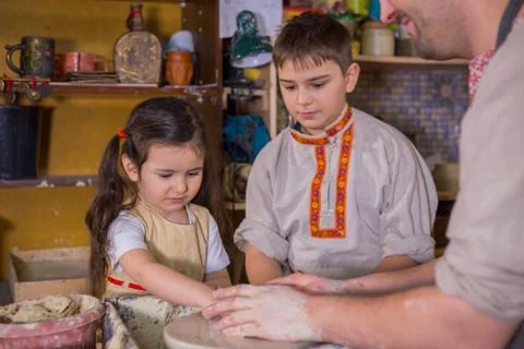 Potter showing how to work with ceramic in pottery studio Stock Photos