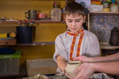 Potter showing how to work with ceramic in pottery studio Stock Photos