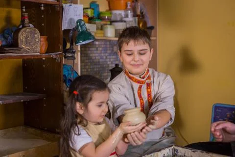Potter showing how to work with ceramic in pottery studio Stock Photos