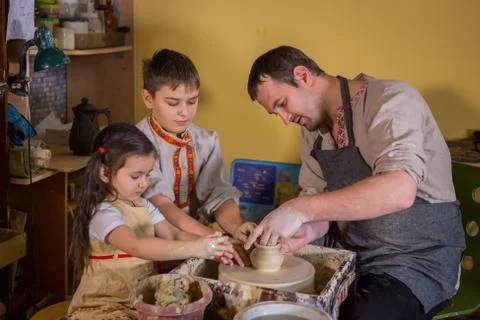 Potter showing how to work with ceramic in pottery studio Stock Photos