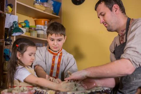 Potter showing how to work with ceramic in pottery studio Stock Photos