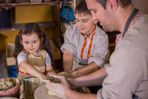 Potter showing how to work with ceramic in pottery studio Stock Photos