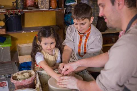 Potter showing how to work with ceramic in pottery studio Stock Photos